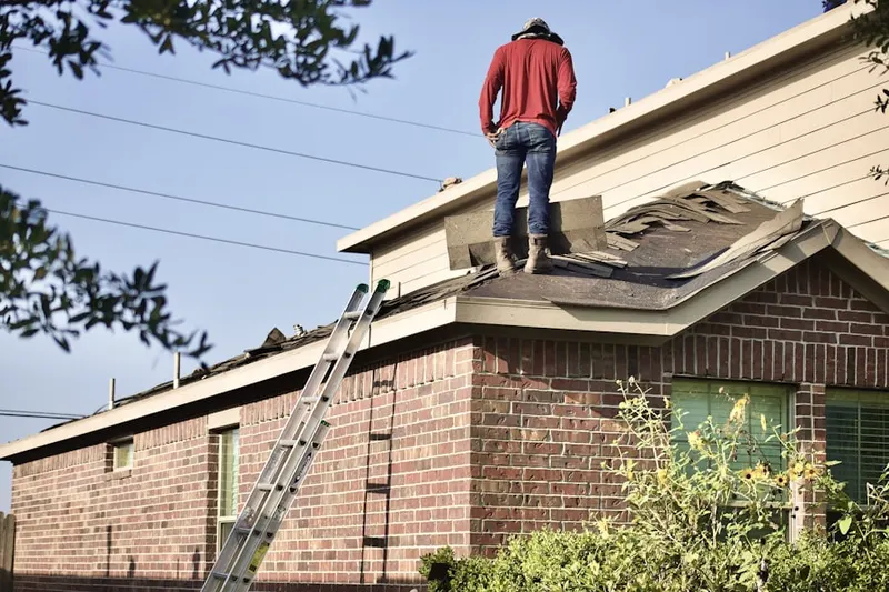 Professional roofer working on a residential roof in San Sebastian
